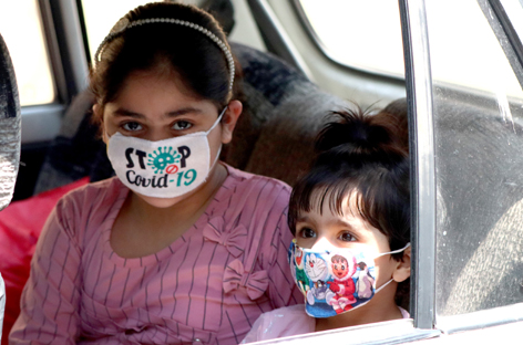 Children travelling in a car wearing masks in Srinagar on Sunday. — Excelsior/Shakeel Children travelling in a car wearing masks in Srinagar on Sunday. — Excelsior/Shakeel