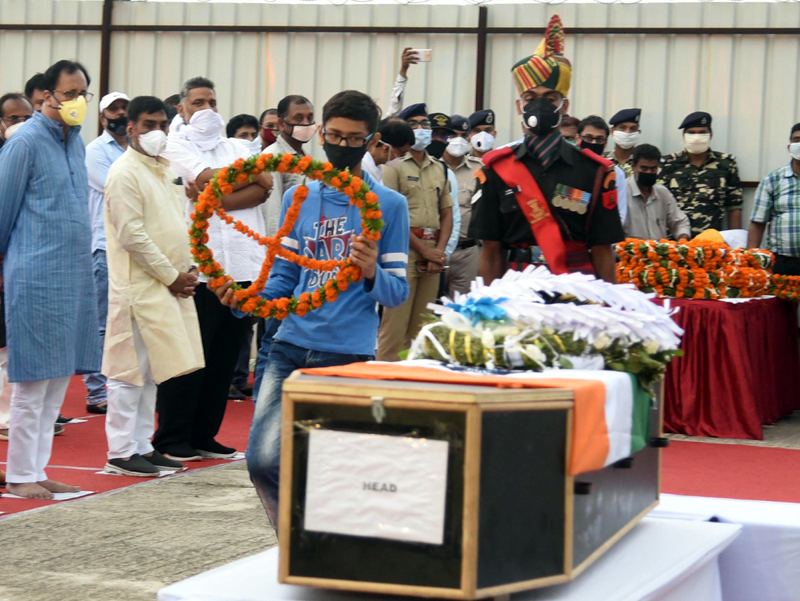 Son of martyred Havildar Sunil Kumar paying tribute to his father during a wreath laying ceremony at Jaiprakash Narayan Airport in Patna on Wednesday. (UNI) Son of martyred Havildar Sunil Kumar paying tribute to his father during a wreath laying ceremony at Jaiprakash Narayan Airport in Patna on Wednesday. (UNI)