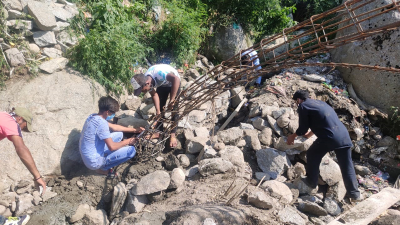Workers of MC Bhaderwah dismantling a structure during anti-encroachment drive. Workers of MC Bhaderwah dismantling a structure during anti-encroachment drive.