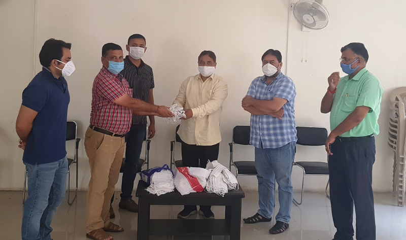 Former BJP president, Sat Sharma distributing face masks at a location of Jammu West Assembly segment on Wednesday. Former BJP president, Sat Sharma distributing face masks at a location of Jammu West Assembly segment on Wednesday.