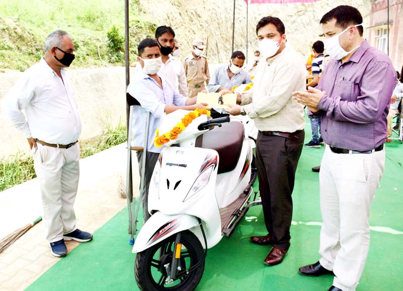 DC Udhampur Dr Piyush Singla handing over scooty to a specially-abled person on Friday. DC Udhampur Dr Piyush Singla handing over scooty to a specially-abled person on Friday.