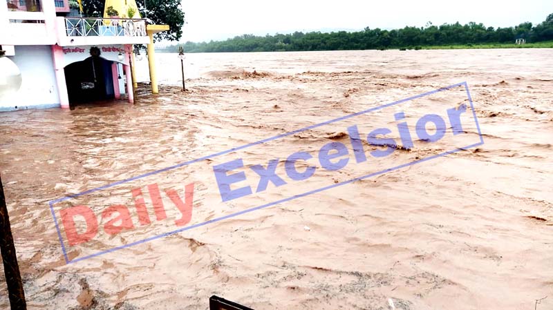 A temple submerges in water as Chenab flows at danger mark near Akhnoor on Thursday. -Excelsior/Rakesh A temple submerges in water as Chenab flows at danger mark near Akhnoor on Thursday. -Excelsior/Rakesh