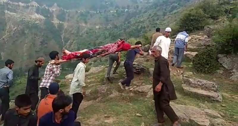 People carrying patient on wooden stretcher. People carrying patient on wooden stretcher.