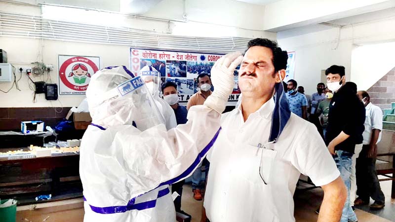 A Health worker checks a person for COVID in Kathua on Monday. -Excelsior/Pradeep Sharma