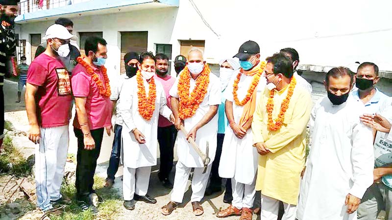 BJP leaders kick starting construction of lane and drain in Gangyal on Sunday. BJP leaders kick starting construction of lane and drain in Gangyal on Sunday.