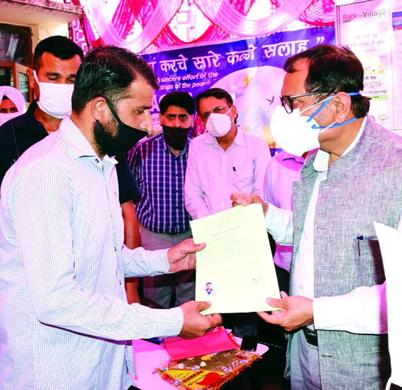 Advisor R R Bhatnagar distributing domicile certificates. Advisor R R Bhatnagar distributing domicile certificates.