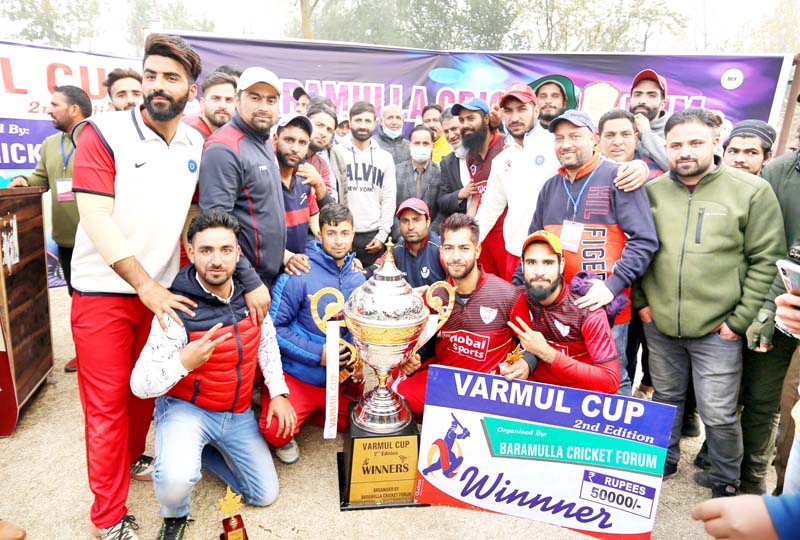 Winning team players posing for a group photograph with winning trophy at Baramulla. Winning team players posing for a group photograph with winning trophy at Baramulla.