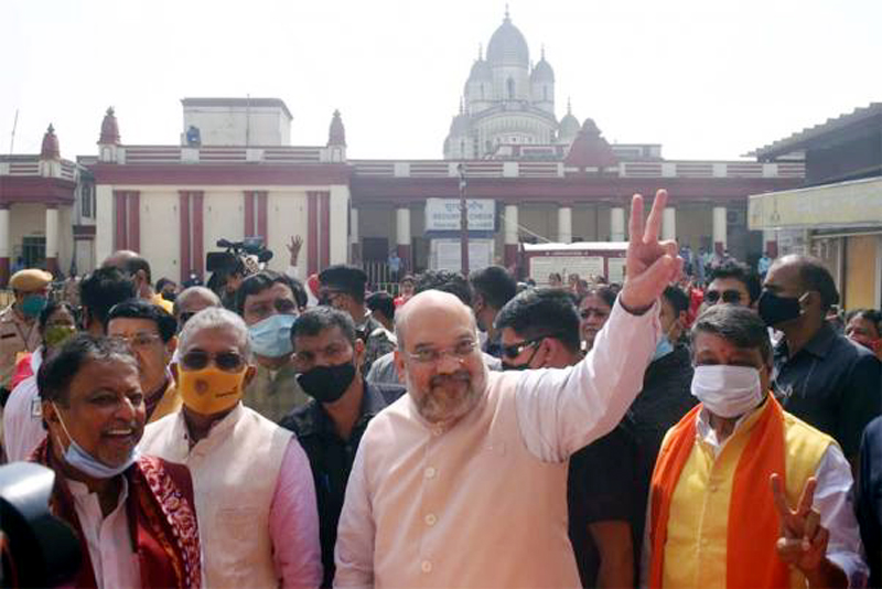 Union Home Minister Amit Shah flashing a victory sign during his visit at Dakshineswar Kali Temple, in Kolkata, Union Home Minister Amit Shah flashing a victory sign during his visit at Dakshineswar Kali Temple, in Kolkata,