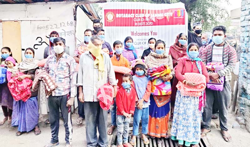 RCJC members posing for a group photograph with residents of a slum area in Jammu after distributing blankets and clothes to them on Monday. RCJC members posing for a group photograph with residents of a slum area in Jammu after distributing blankets and clothes to them on Monday.