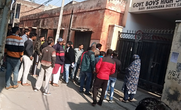 Voters outside a polling station in Bari Brahamna with almost none wearing face mask on Tuesday. Voters outside a polling station in Bari Brahamna with almost none wearing face mask on Tuesday.