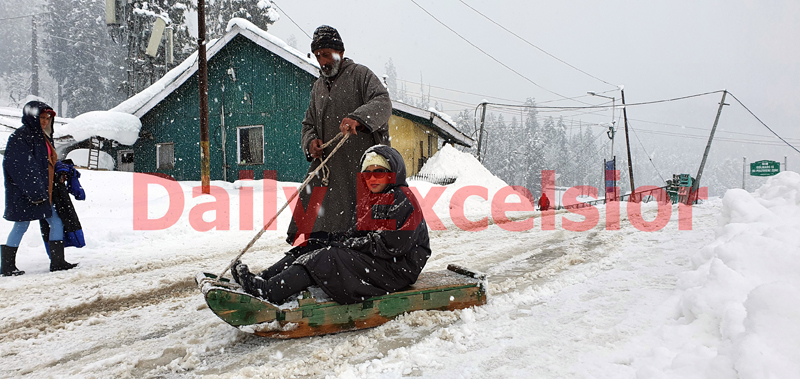 Tourists enjoying snowfall at Gulmarg on Tuesday. -Excelsior/Aabid Nabi Tourists enjoying snowfall at Gulmarg on Tuesday. -Excelsior/Aabid Nabi
