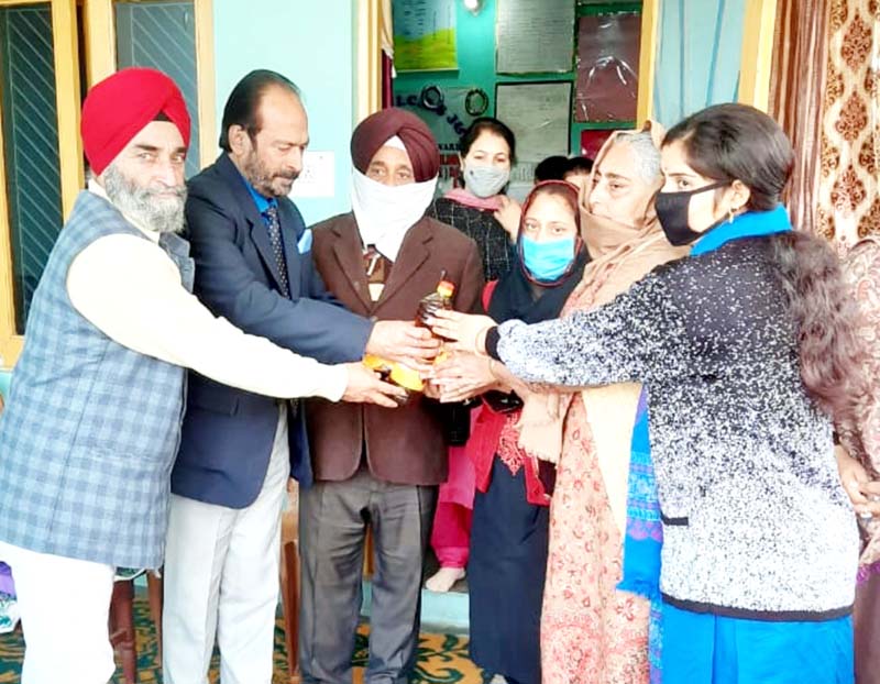 JMC Councillor, Prof. Yudhvir Singh and others distributing food items to Anganwadi Workers. JMC Councillor, Prof. Yudhvir Singh and others distributing food items to Anganwadi Workers.