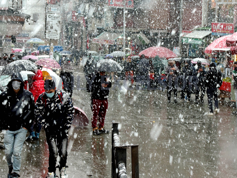 People cover themselves under umbrellas as Srinagar experiences fresh snowfall on Monday. (UNI) People cover themselves under umbrellas as Srinagar experiences fresh snowfall on Monday. (UNI)