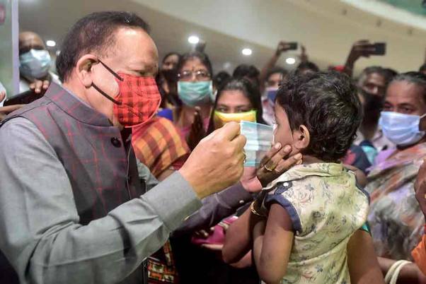 Union Health Minister Harsh Vardhan helps a child wear a face mask during his visit to review the dry run for administering COVID-19 vaccine at Tamil Nadu Government Multi Super Speciality Hospital, in Chennai. Union Health Minister Harsh Vardhan helps a child wear a face mask during his visit to review the dry run for administering COVID-19 vaccine at Tamil Nadu Government Multi Super Speciality Hospital, in Chennai.