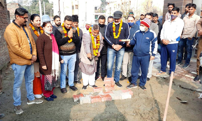 Former BJP State president, Sat Sharma kick-starting construction of lane at Subash Nagar on Sunday. Former BJP State president, Sat Sharma kick-starting construction of lane at Subash Nagar on Sunday.