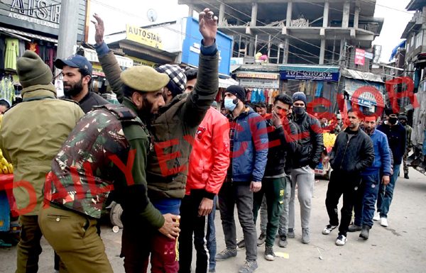 Security forces conduct searches of pedestrians in Lal Chowk area of Srinagar on Monday. —Excelsior/Shakeel