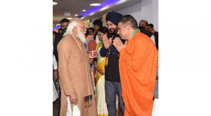 BJP president Ravinder Raina and national secretary Narinder Singh with Prime Minister Narendra Modi in New Delhi on Sunday.