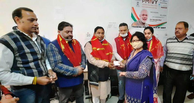 Former Minister, Sat Sharma handing over Ayushman cards to people in Jammu on Thursday. Former Minister, Sat Sharma handing over Ayushman cards to people in Jammu on Thursday.