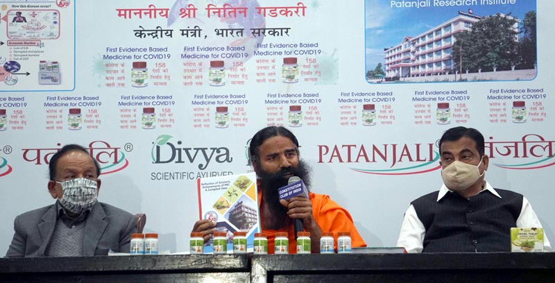Yog Guru Swami Ramdev flanked by Union Minister of Road Transport and Highways Nitin Gadkar and Union Minister for Health and Family Welfare Dr. Harshvardhan during the launch of the first evidence based medicine for COVID-19, in New Delhi on Friday. (UNI) Yog Guru Swami Ramdev flanked by Union Minister of Road Transport and Highways Nitin Gadkar and Union Minister for Health and Family Welfare Dr. Harshvardhan during the launch of the first evidence based medicine for COVID-19, in New Delhi on Friday. (UNI)