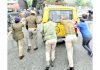 Cops push police vehicle carrying a cop injured during Congress protest rally to start it on way to hospital in Jammu on Monday. -Excelsior/Rakesh