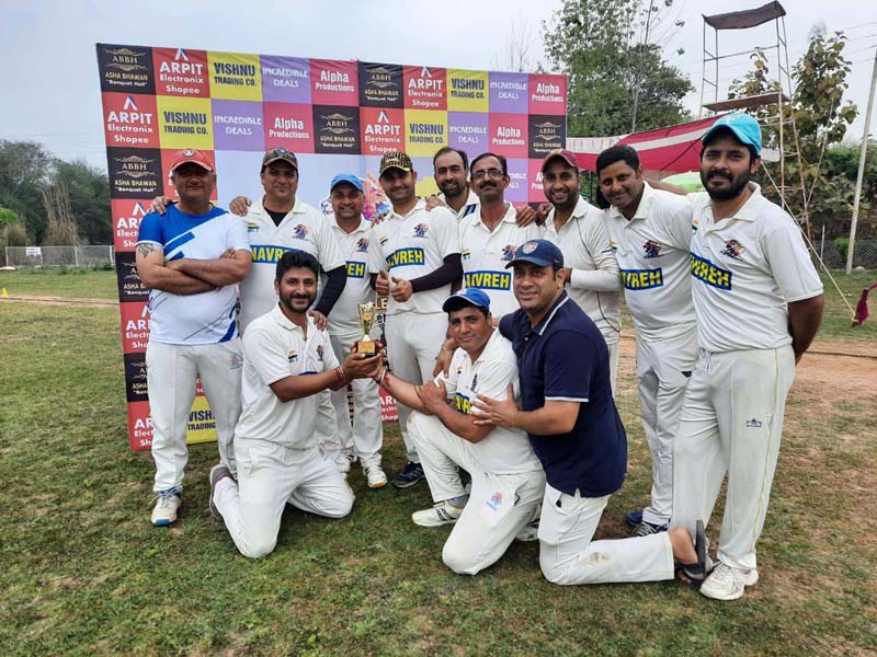 Players posing for group photograph along with trophy at Bhalwal in Jammu.