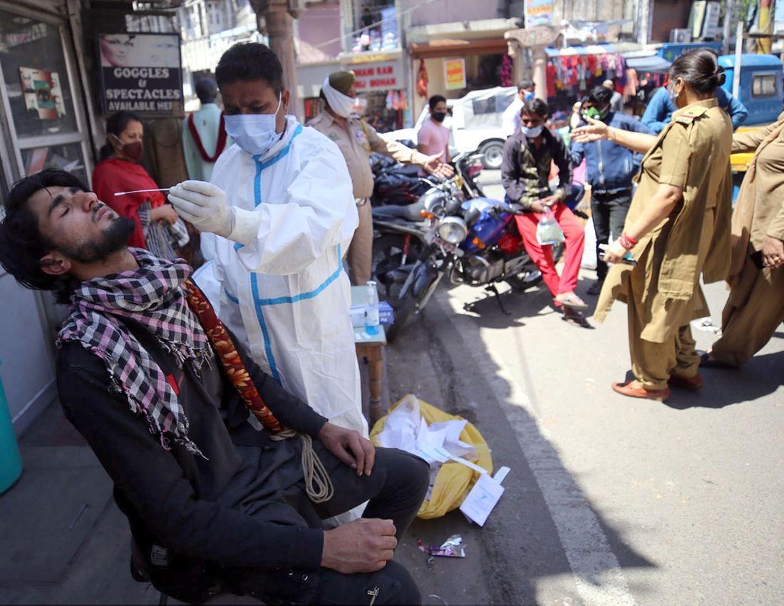 A man being tested for COVID-19 at City Chowk Jammu on Monday. -Excelsior/Rakesh A man being tested for COVID-19 at City Chowk Jammu on Monday. -Excelsior/Rakesh