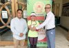 Principal of KC Public School Amarendra Mishra congratulating Shreemai Bhat for clinching Sliver medal in Soft Tennis Championship at Jammu.