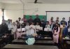 Winners of symposium displaying meritorious certificates along with dignitaries at Rajouri.