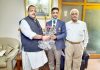 NC leader Devender Singh Rana presenting bouquet to Gold Medal winner shooter Chain Singh at Jammu.