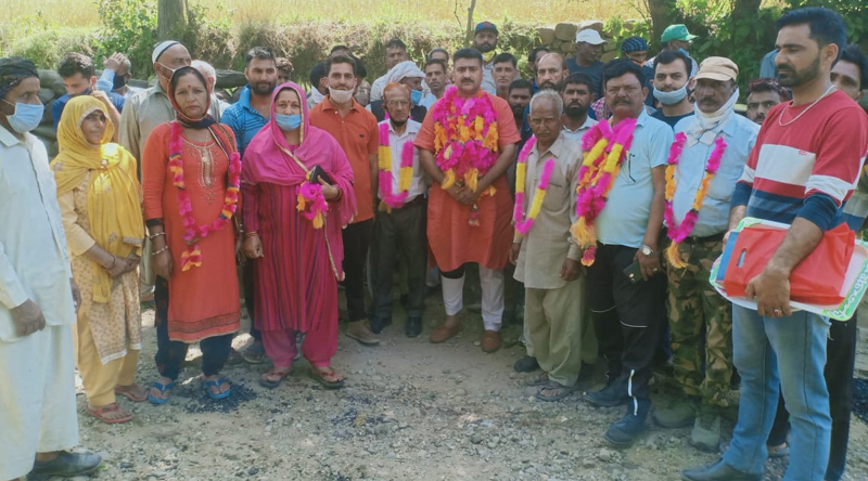 President AJKPC, Anil Sharma along with others poses for a group photograph after start of road blacktopping work. President AJKPC, Anil Sharma along with others poses for a group photograph after start of road blacktopping work.