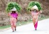 Women returning home from fields with fodder on their heads at village Payar in Pulwama district. -Excelsior/Younis Khaliq