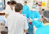Attired in PPE Kits, SDRF men assisting in Covid wards at Government Medical College Jammu on Tuesday. (UNI)