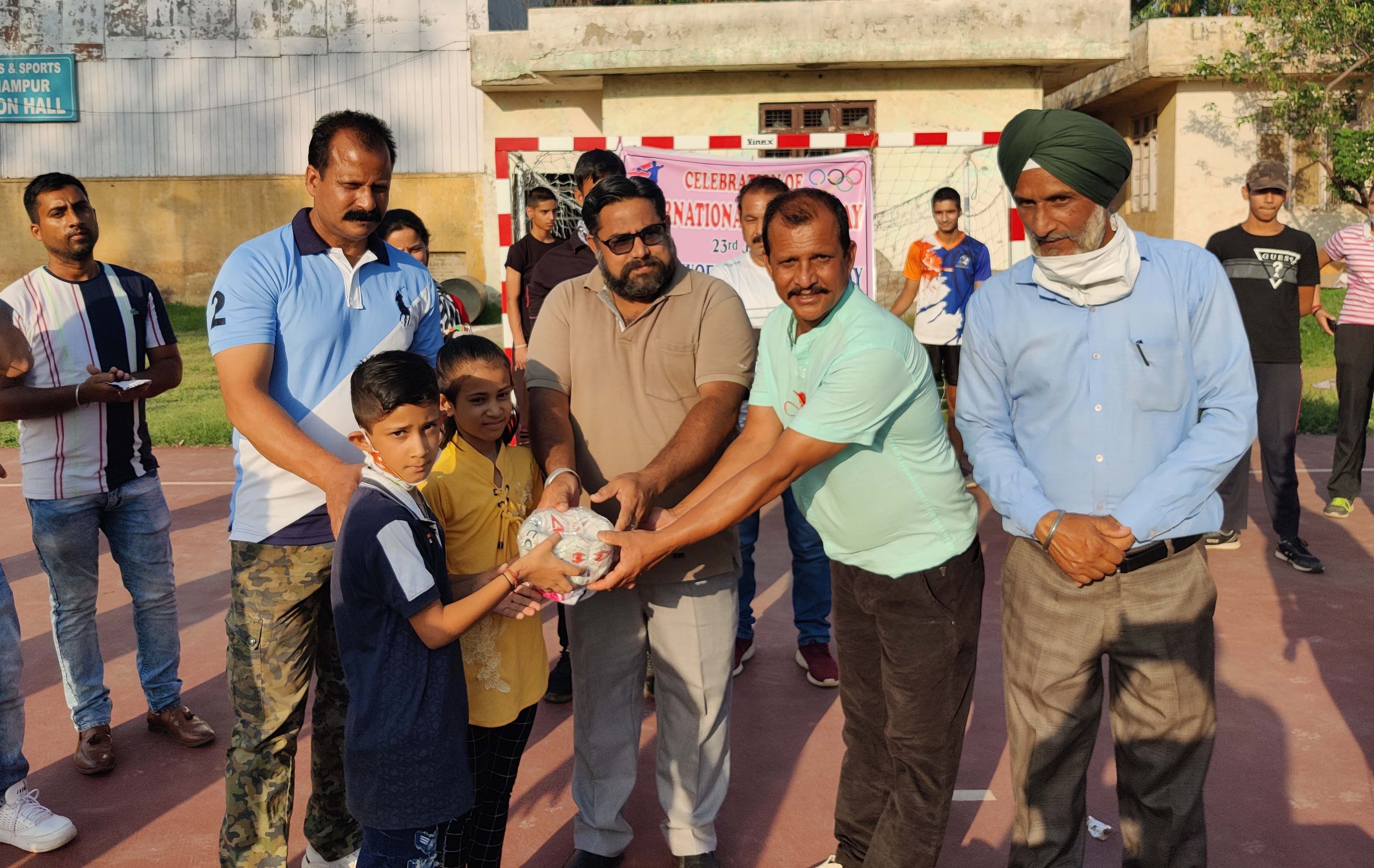Officials of DYS&S distributing handballs among students in Udhampur. Officials of DYS&S distributing handballs among students in Udhampur.