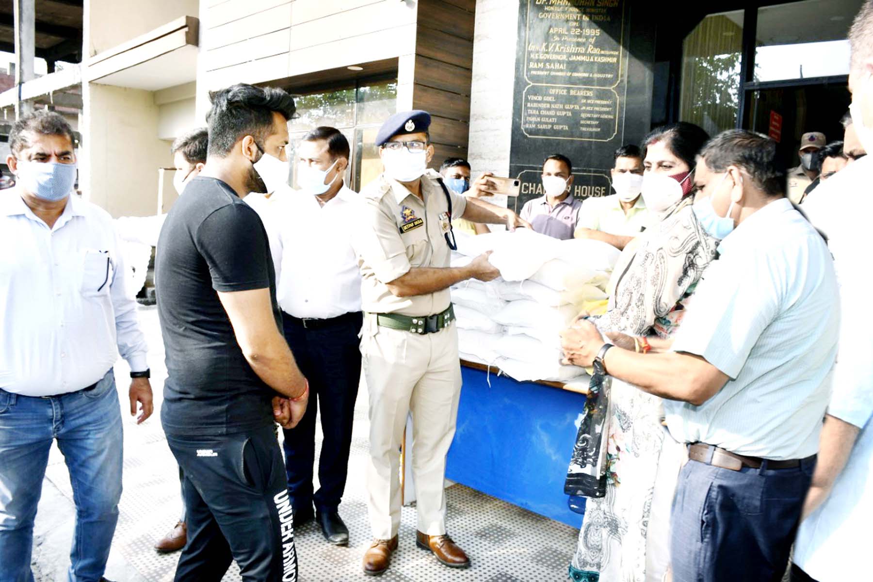 JMC Mayor, JCCI president and others distributing food items among needy in Jammu. JMC Mayor, JCCI president and others distributing food items among needy in Jammu.