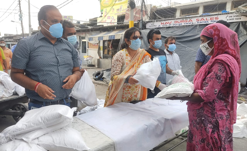 Director Industries Anu Malhotra distributing ration kits among needy at Ware House Jammu on Saturday. Director Industries Anu Malhotra distributing ration kits among needy at Ware House Jammu on Saturday.