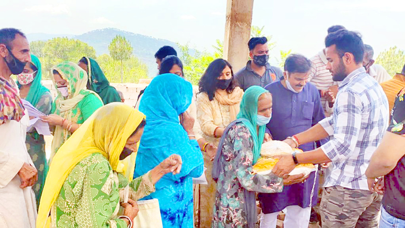Former Minister, Harshdev Singh distributing ration among people in Ramnagar area on Friday. Former Minister, Harshdev Singh distributing ration among people in Ramnagar area on Friday.