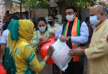 BJP MP (RS) Syed Zafar Islam and JKUT VP Yudhvir Sethi distributing ration kits among people at Kalaka Colony on Wednesday.