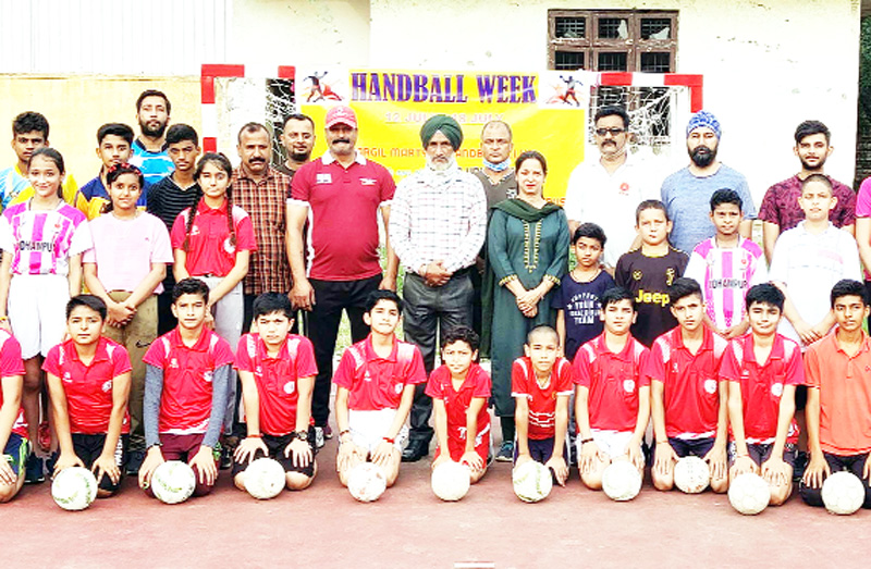 Young and senior players posing for a group photograph during inaugural ceremony of Handball week at Udhampur on Monday.