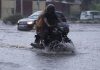 A bike rider moving through a flooded road in Gandhi Nagar area of Jammu on Saturday. — Excelsior/Rakesh
