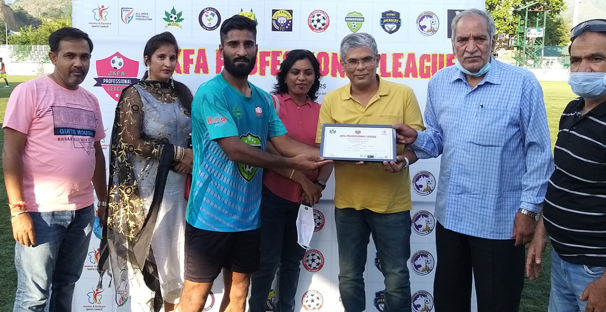 A player being awarded with man of the match award by dignitaries at Srinagar during Football Professional League on Friday.
