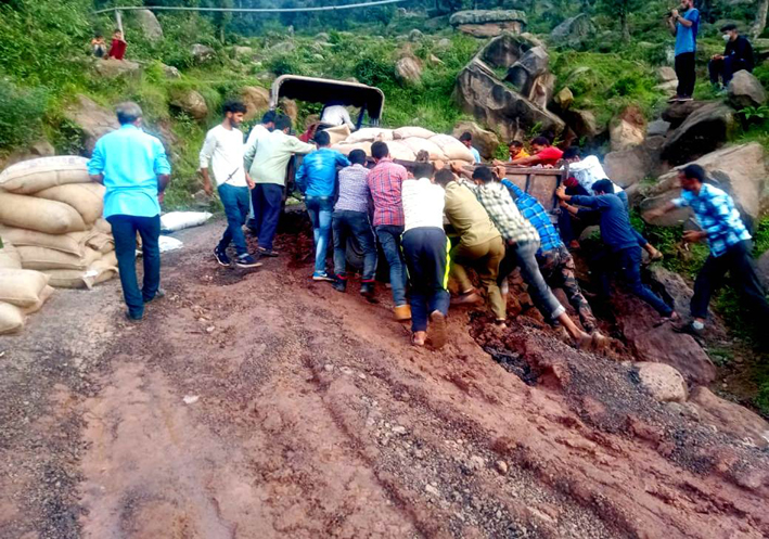 Villagers pushing up a loaded tractor trolly to make way on muddy PMGSY road. -Excelsior/K Kumar Villagers pushing up a loaded tractor trolly to make way on muddy PMGSY road. -Excelsior/K Kumar