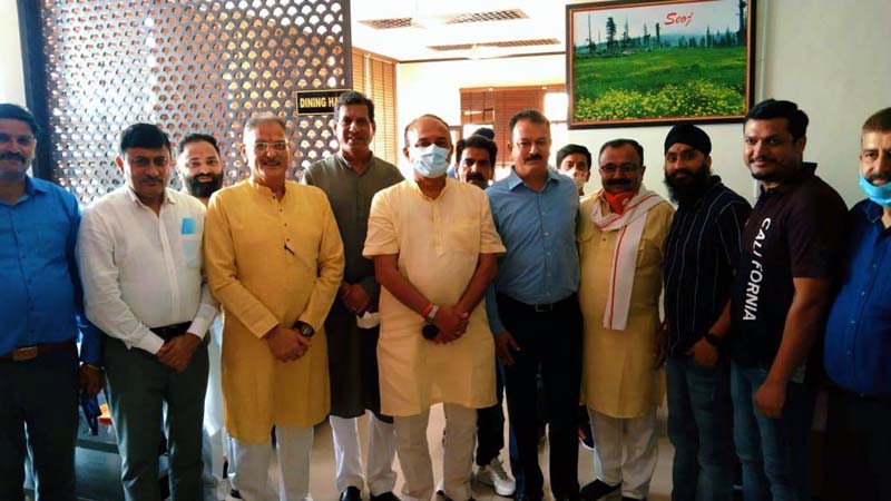 BJP leader and former Dy Chief Minister, Kavinder Gupta posing for a group photograph on Friday.