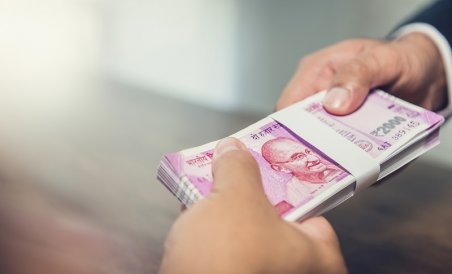 Businessman giving money, Indian rupee currency, to his partner-1587886700