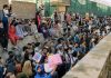 Afghans outside the walls of Kabul airport wait for their chance to enter inside on Friday.