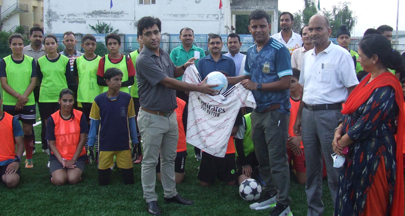 International footballer, Arun Malhotra felicitating ADC Jammu Rakesh Dubey with T-shirt and football after the camp at Khel Gaon Nagrota on Saturday. International footballer, Arun Malhotra felicitating ADC Jammu Rakesh Dubey with T-shirt and football after the camp at Khel Gaon Nagrota on Saturday.