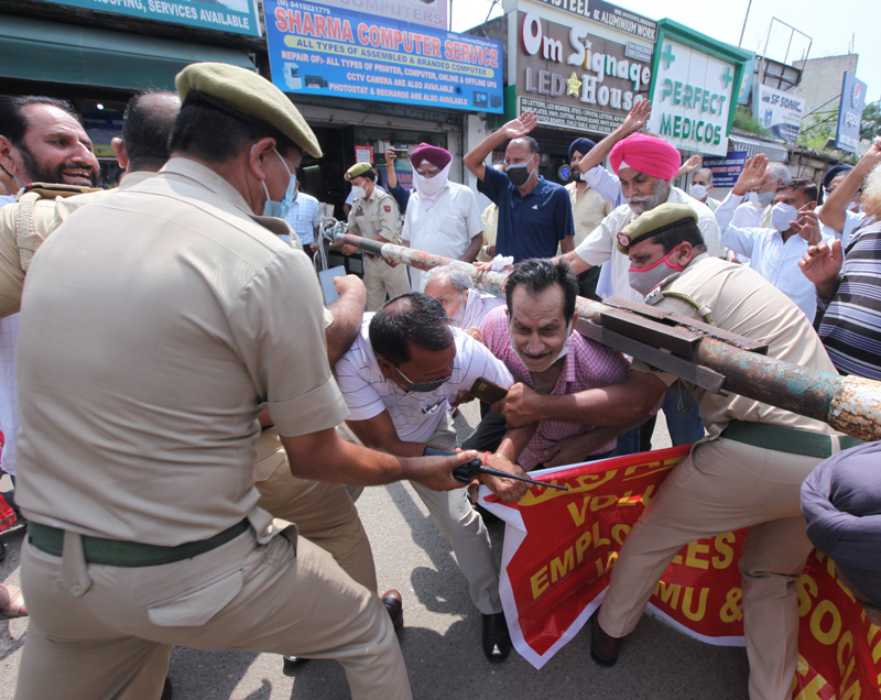 Protesting VRS given JKRTC workers being stopped by police near Dogra Chowk in Jammu on Wednesday. —Excelsior/ Rakesh