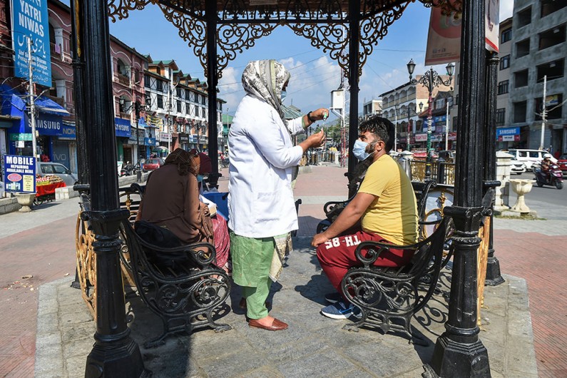 A medic prepares to administer a dose of COVID-19 vaccine to a beneficiary in Srinagar
