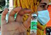 A paramedical staffer holding a COVID-19 vaccine in Lal Chowk area of Srinagar during a drive to immunize all citizens above 18 years to control the spread of Coronavirus infection on Tuesday. (UNI)