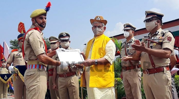 Lieutenant Governor Manoj Sinha awarding a new recruit at SKPA Udhampur on Thursday. -Excelsior/K Kumar