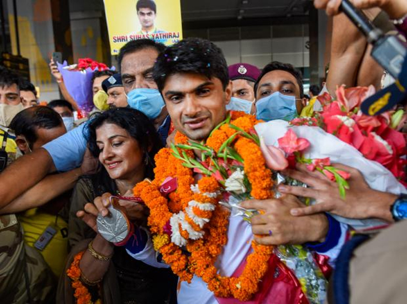 Tokyo Paralympic 2020 Silver medalist Suhas L Yathiraj with wife Ritu LY, being welcomed on arrival at IGI Airport in New Delhi on Monday. (UNI)